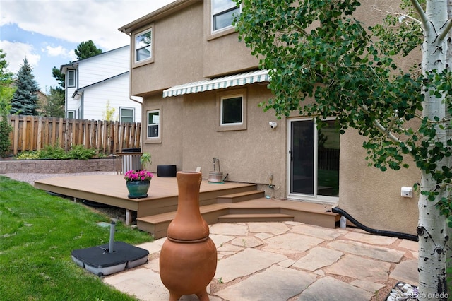 2859 Front Royal Dr, Colorado Springs, CO 80919 - rear view of house with stucco siding, a deck, and a patio area
