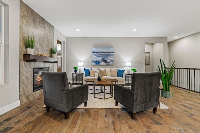 living area featuring a fireplace, wood finished floors, and recessed lighting