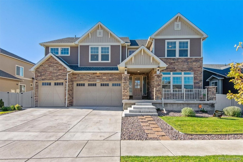 craftsman-style house with a front yard and a garage