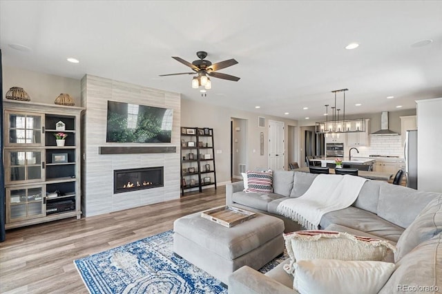 7074 S Vandriver Ct, Aurora, CO 80016 - living area featuring a ceiling fan, light wood-style floors, recessed lighting, and a tile fireplace