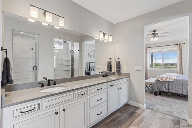 7074 S Vandriver Ct, Aurora, CO 80016 - full bathroom featuring ensuite bath, double vanity, wood finished floors, a stall shower, and a ceiling fan