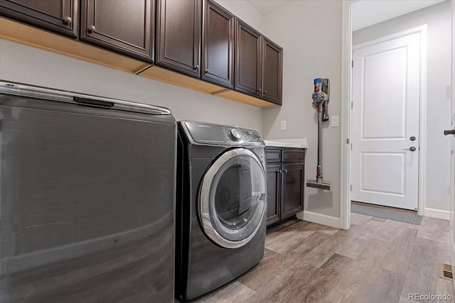7074 S Vandriver Ct, Aurora, CO 80016 - laundry room with cabinet space, light wood-type flooring, and separate washer and dryer