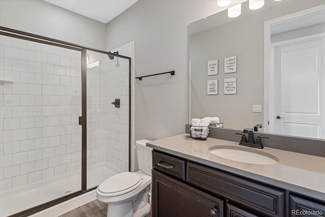 7074 S Vandriver Ct, Aurora, CO 80016 - bathroom featuring vanity, a stall shower, and wood finished floors