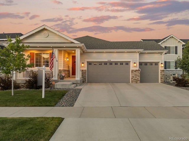 7074 S Vandriver Ct, Aurora, CO 80016 - view of front of house with a garage, driveway, a porch, board and batten siding, and a front yard