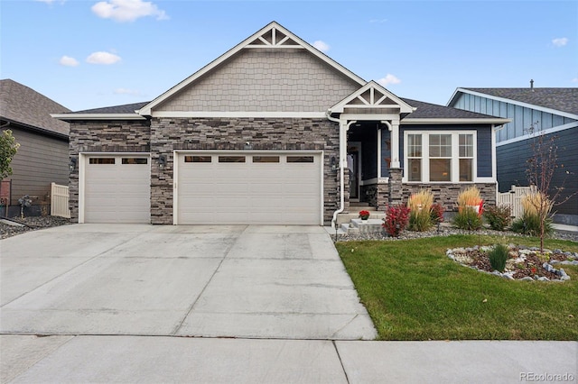 craftsman-style house featuring a garage and a front lawn