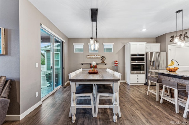 dining area featuring dark hardwood / wood-style floors and a notable chandelier