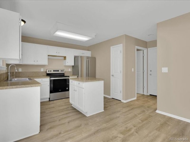 8906 Miners Dr, Highlands Ranch, CO 80126 - kitchen featuring appliances with stainless steel finishes, light wood finished floors, white cabinets, and light countertops