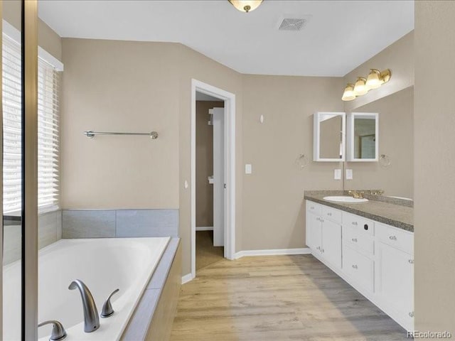 8906 Miners Dr, Highlands Ranch, CO 80126 - bathroom featuring vanity, a bath, and wood finished floors