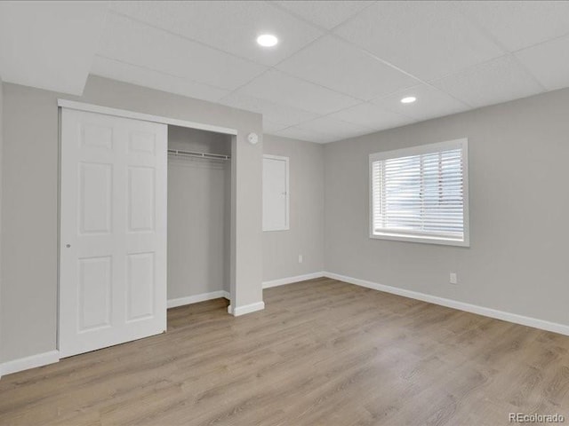 8906 Miners Dr, Highlands Ranch, CO 80126 - unfurnished bedroom with a closet, wood finished floors, a paneled ceiling, and recessed lighting