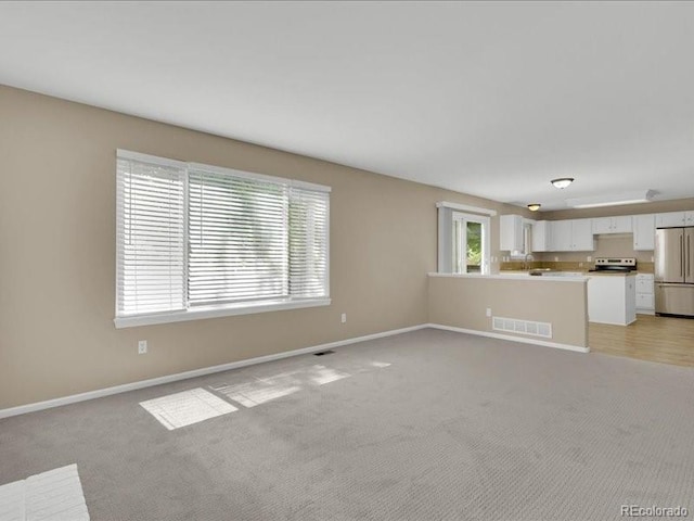 8906 Miners Dr, Highlands Ranch, CO 80126 - unfurnished living room with light colored carpet and baseboards