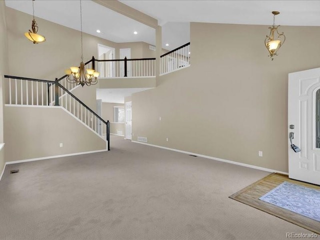 8906 Miners Dr, Highlands Ranch, CO 80126 - carpeted foyer entrance with high vaulted ceiling, stairway, a chandelier, and recessed lighting