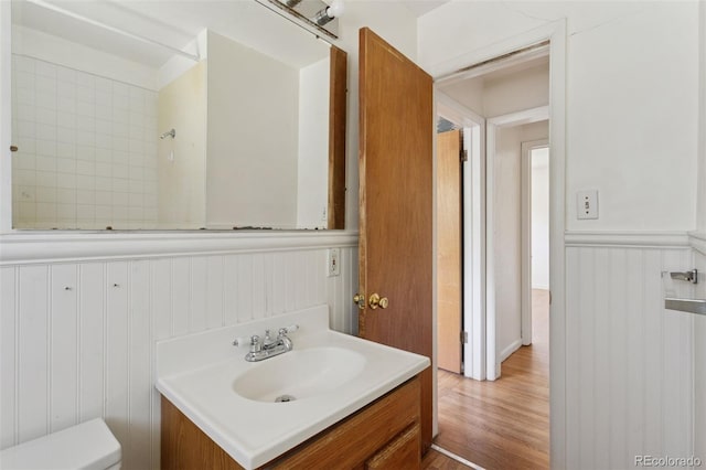 1585 S University Blvd, Denver, CO 80210 - bathroom featuring vanity, wainscoting, and wood finished floors