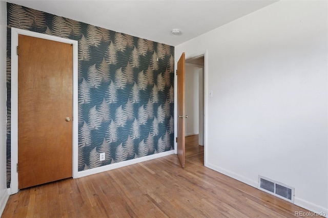 1585 S University Blvd, Denver, CO 80210 - spare room featuring wood finished floors and a smoke detector