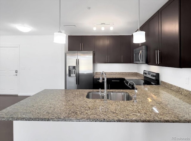 1062 Rockhurst Dr Unit 302, Highlands Ranch, CO 80129 - kitchen with appliances with stainless steel finishes, a sink, stone counters, dark brown cabinets, and a peninsula