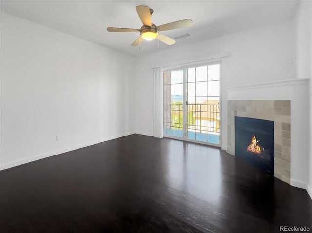 1062 Rockhurst Dr Unit 302, Highlands Ranch, CO 80129 - unfurnished living room with a tile fireplace, a ceiling fan, and baseboards