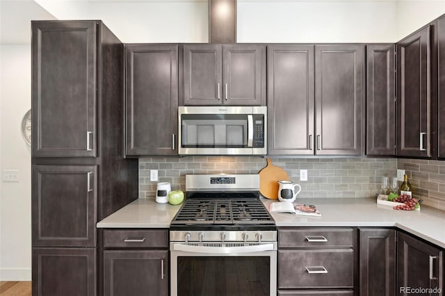 7812 W 43rd Pl, Wheat Ridge, CO 80033 - kitchen featuring appliances with stainless steel finishes, light countertops, dark brown cabinets, and decorative backsplash