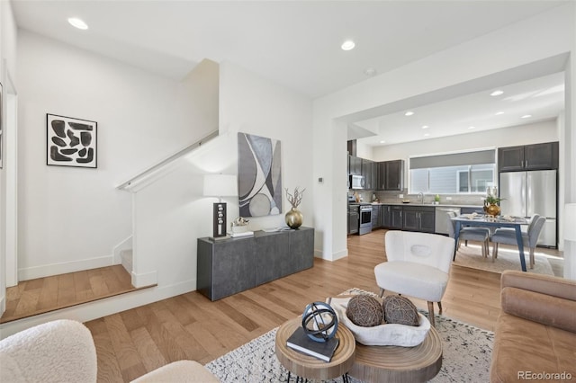 7812 W 43rd Pl, Wheat Ridge, CO 80033 - living room featuring light wood-type flooring, stairway, recessed lighting, and baseboards