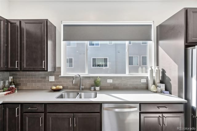 7812 W 43rd Pl, Wheat Ridge, CO 80033 - kitchen featuring stainless steel appliances, a sink, dark brown cabinets, light countertops, and decorative backsplash