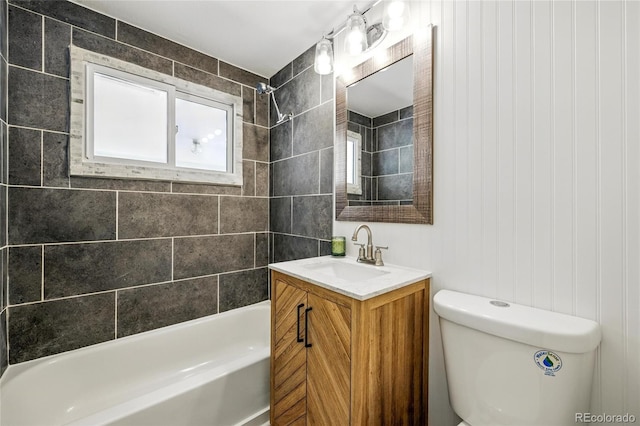 bathroom with bathtub / shower combination, toilet, and vanity