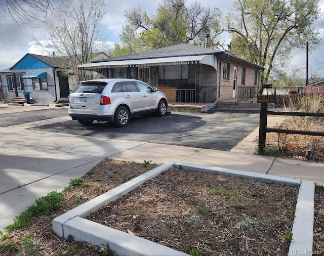1822 E Pikes Peak Ave, Colorado Springs, CO 80909 - view of front of house with brick siding and driveway