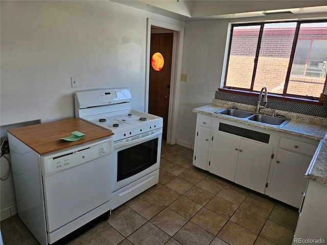 1822 E Pikes Peak Ave, Colorado Springs, CO 80909 - kitchen with white appliances, a sink, light countertops, and white cabinets