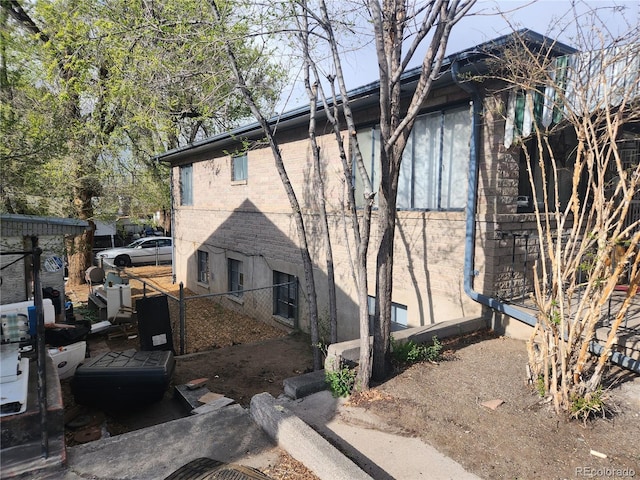 1822 E Pikes Peak Ave, Colorado Springs, CO 80909 - view of property exterior featuring brick siding and fence