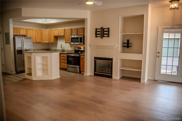 2980 W Centennial Dr Unit L, Littleton, CO 80123 - kitchen with stainless steel appliances, built in shelves, open shelves, and light wood finished floors