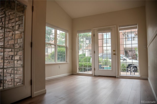 2980 W Centennial Dr Unit L, Littleton, CO 80123 - doorway to outside featuring wood finished floors, vaulted ceiling, and baseboards
