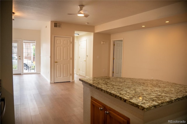 2980 W Centennial Dr Unit L, Littleton, CO 80123 - kitchen with light wood-style flooring, light stone countertops, a ceiling fan, recessed lighting, and baseboards