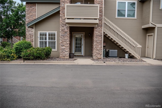 2980 W Centennial Dr Unit L, Littleton, CO 80123 - view of exterior entry with central AC unit and stone siding