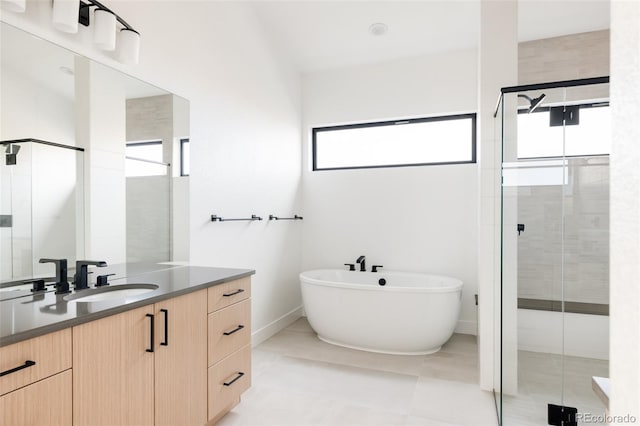 bathroom featuring tile patterned floors, vanity, and plus walk in shower