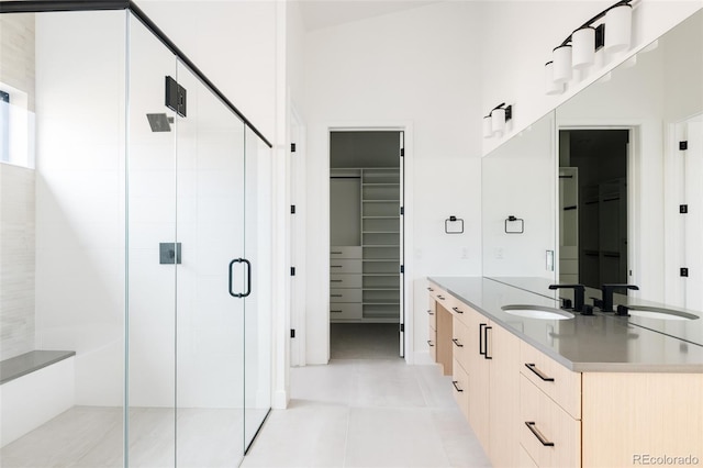 bathroom with vanity, tile patterned floors, and a shower with shower door