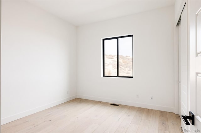 unfurnished room with light wood-type flooring