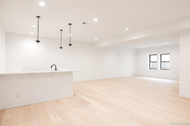 interior space with sink and light wood-type flooring