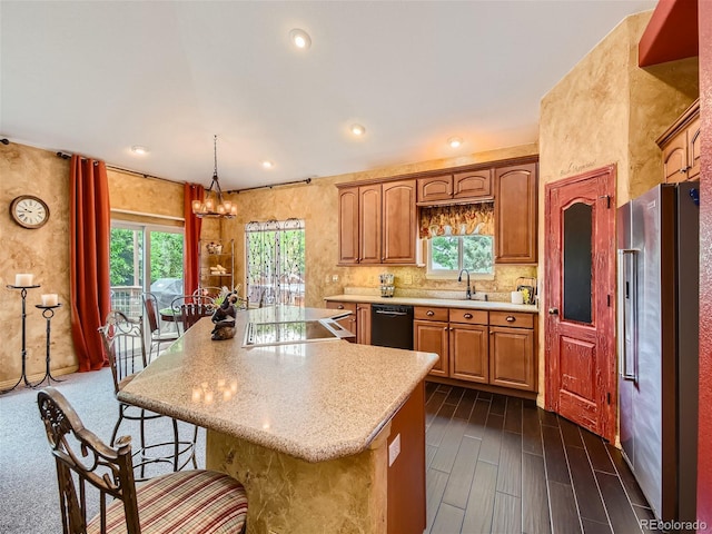 kitchen featuring black dishwasher, high end refrigerator, a center island, and hanging light fixtures