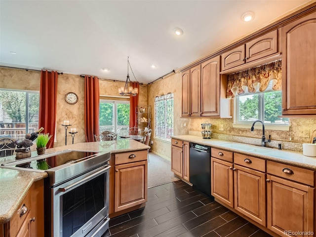 kitchen featuring pendant lighting, plenty of natural light, black dishwasher, and stainless steel range