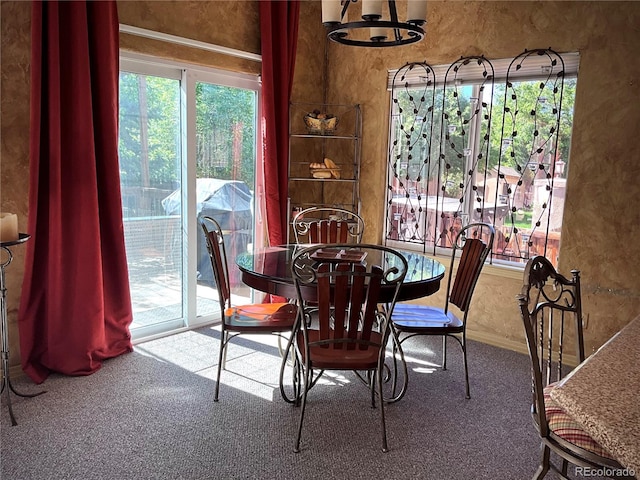 carpeted dining room with a notable chandelier