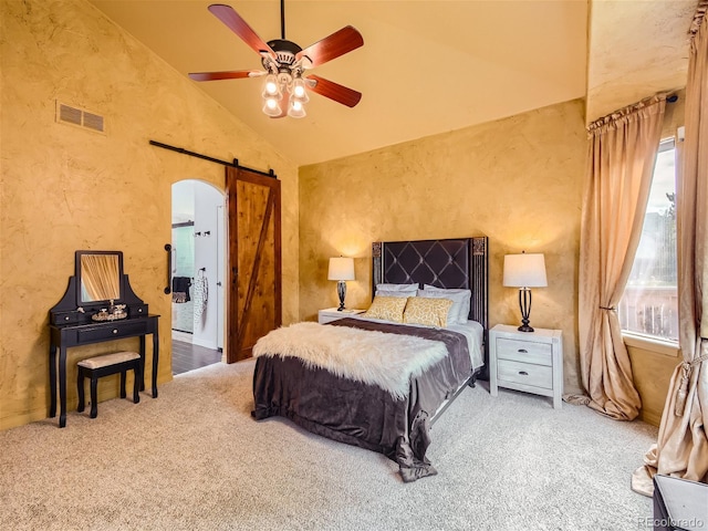 carpeted bedroom with a barn door, high vaulted ceiling, and ceiling fan