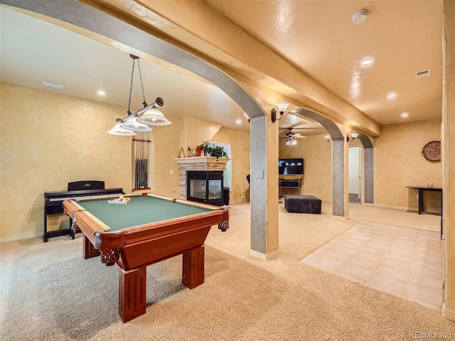 game room with ceiling fan, beamed ceiling, billiards, carpet floors, and a fireplace