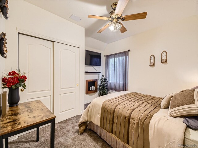 bedroom featuring light carpet, a closet, vaulted ceiling, and ceiling fan