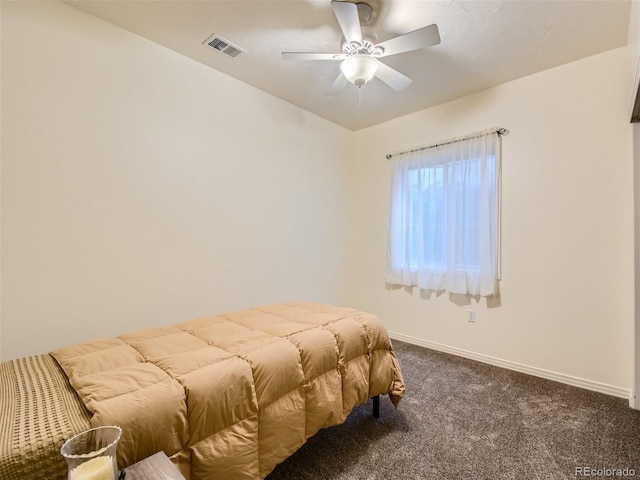 bedroom with ceiling fan and dark carpet