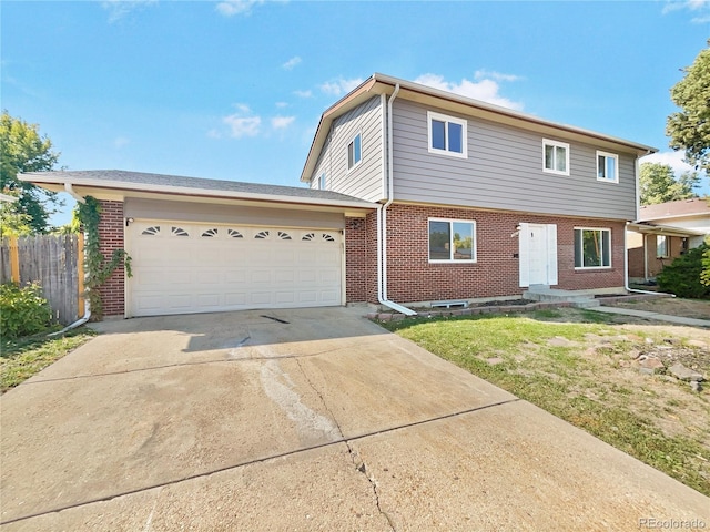 view of front of property featuring a garage and a front lawn