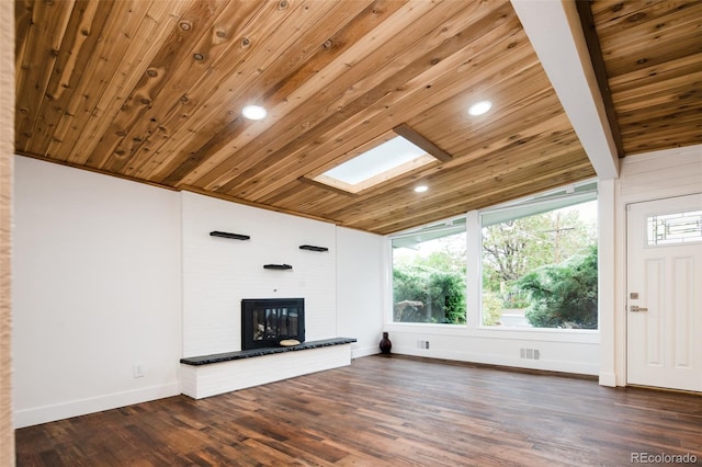7695 Quitman St, Westminster, CO 80030 - unfurnished living room with wood ceiling, baseboards, a skylight, a brick fireplace, and dark wood-style floors