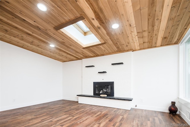 7695 Quitman St, Westminster, CO 80030 - unfurnished living room with wood ceiling, a skylight, a brick fireplace, recessed lighting, and wood finished floors