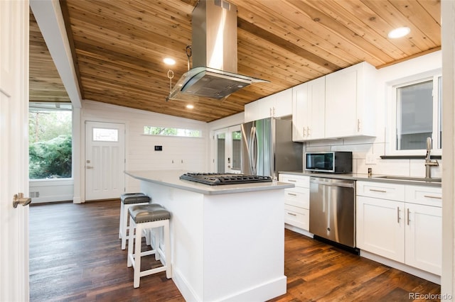 7695 Quitman St, Westminster, CO 80030 - kitchen featuring stainless steel appliances, island range hood, wooden ceiling, a center island, and decorative backsplash