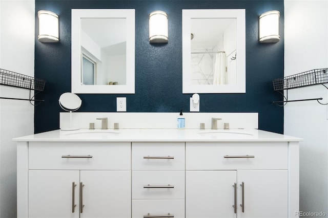7695 Quitman St, Westminster, CO 80030 - bathroom featuring double vanity, a shower with curtain, and a textured wall