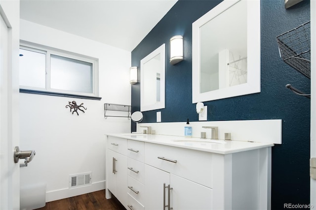 7695 Quitman St, Westminster, CO 80030 - bathroom with double vanity, baseboards, and wood finished floors