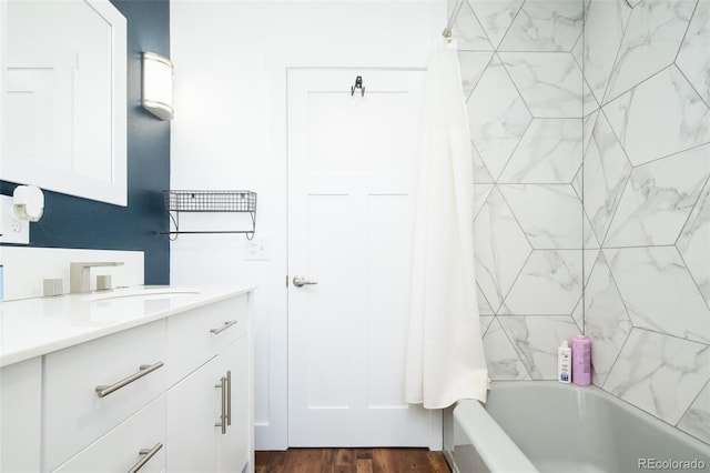 7695 Quitman St, Westminster, CO 80030 - full bathroom with vanity, shower / tub combo with curtain, and wood finished floors