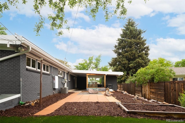 7695 Quitman St, Westminster, CO 80030 - back of house with central AC, brick siding, and a patio area
