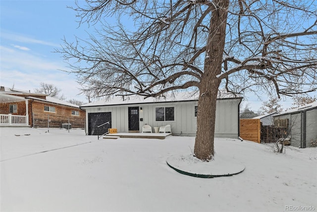 view of snow covered back of property